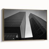 Framed canvas featuring a vintage-style landscape painting of a European scene in black and gold tones.