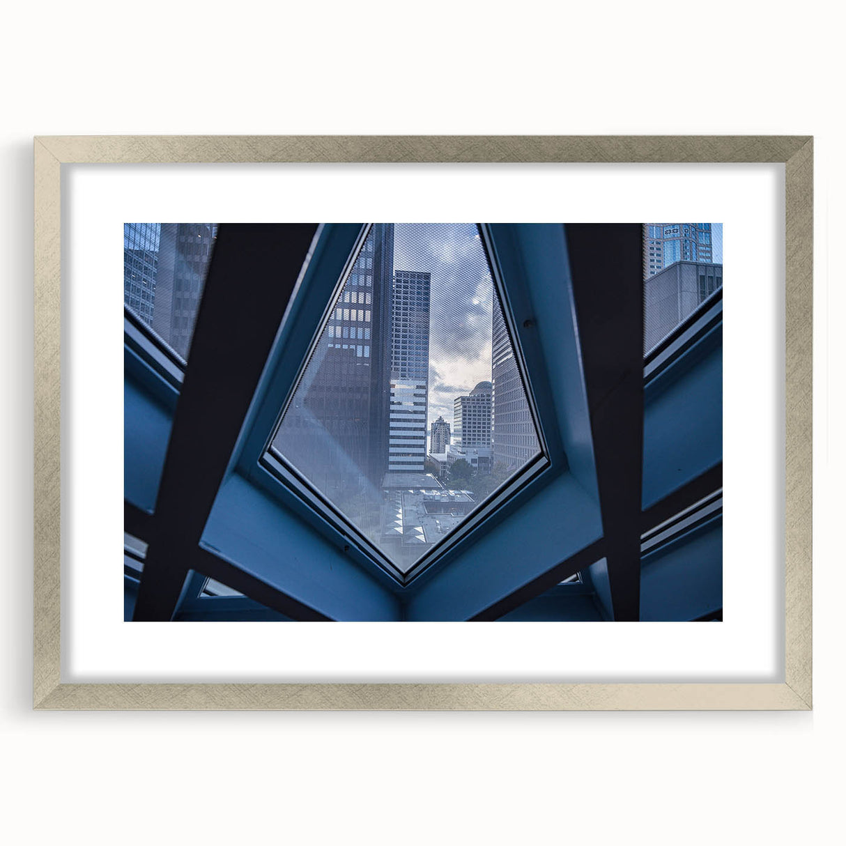 Textured abstract art print of Seattle skyline in muted gray and silver, framed with a mat, ideal for bedroom art.