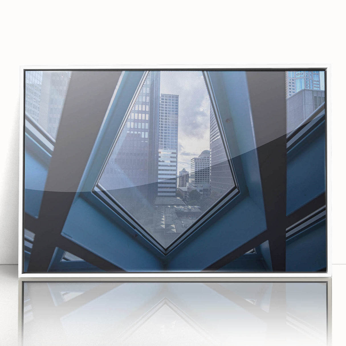 Acrylic print of Seattle skyline in muted gray tones, framed in white, suitable for modern art wall decor.