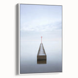 Framed abstract landscape canvas artwork showcasing soft hues of blue and cream, elegantly displayed with a white frame, perfect for modern home decor.