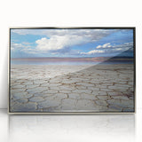 Framed acrylic artwork depicting an abstract landscape in silver tones, showcasing fluid shapes and textures, perfect for modern home decor and art enthusiasts.