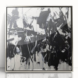 Framed abstract wall art featuring vibrant splatter designs in shades of blue, yellow, and red, elegantly displayed with a sleek silver frame on a white background.