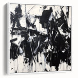 Framed canvas artwork featuring abstract splatter designs in vibrant colors, showcasing a modern aesthetic with a sleek white frame, ideal for contemporary home decor.