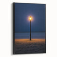 Framed canvas artwork depicting serene sand dunes in warm tones, showcasing a black frame and side view, perfect for enhancing modern home decor.