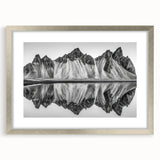 Textured art depicting abstract Alaskan scenery in muted gray and silver tones, framed with a silver mat.