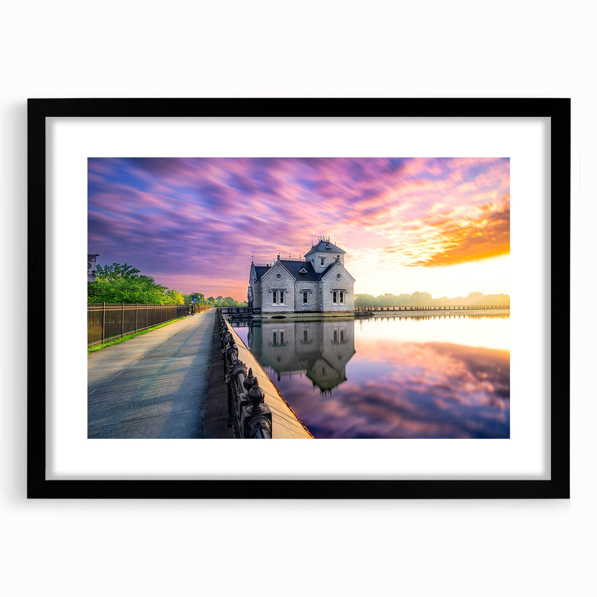 Abstract art print featuring vibrant colors and textured details on a large black-framed canvas, ideal for living room decor.