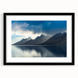 Colorful abstract art print of the Grand Tetons in vibrant hues on a large textured canvas, ideal for living room decor.