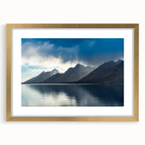 Extra large wall art featuring an abstract print of the Grand Tetons, in textured tones of blue and gray, framed in gold.