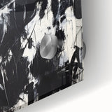 Close-up of an abstract acrylic glass artwork showcasing vibrant splatters of blue, orange, and yellow, perfect for modern home decor and artistic inspiration.