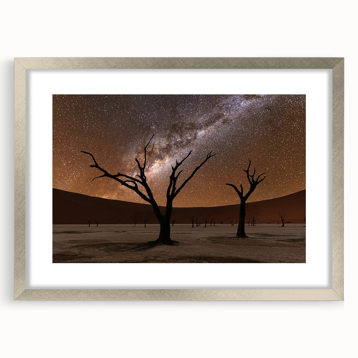 Abstract art print of African scenery in muted earth tones on a framed silver mat, suitable for dining room decor.