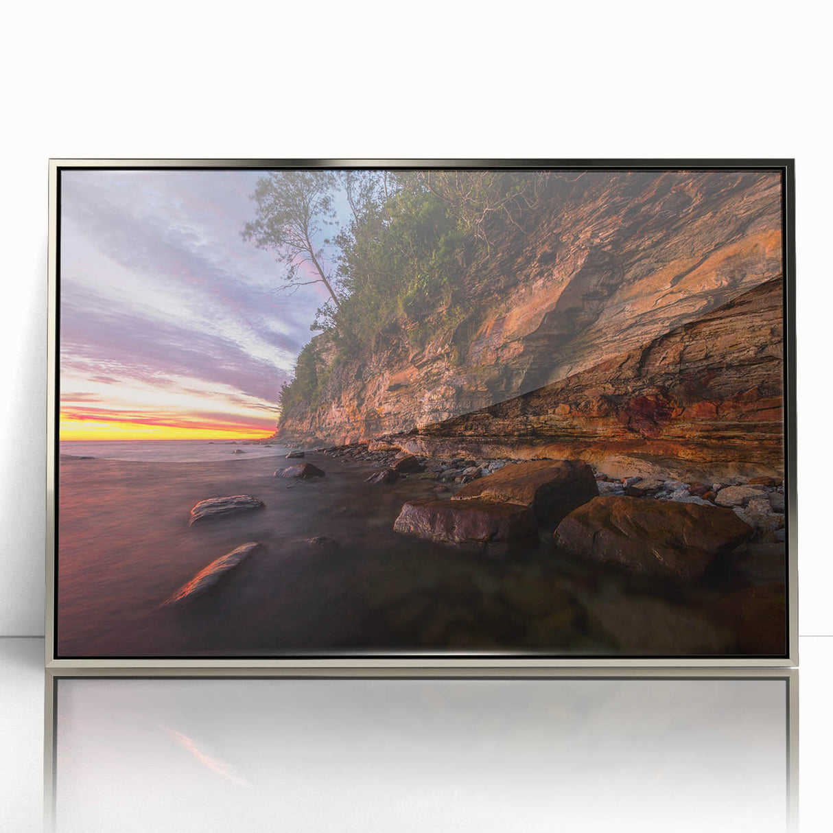 Large art print of a serene Finnish landscape in muted earth tones on a silver-framed acrylic.