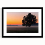 Abstract art print featuring vibrant, colorful textures of a European scenery on a large black-framed canvas.