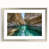 Textured art depicting an abstract Middle Eastern scenery in muted earth tones, framed with a silver mat.