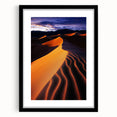 Black-framed landscape artwork featuring serene sand dunes under a clear blue sky, elegantly displayed with a white mat, perfect for modern decor.