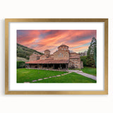 Abstract art print of a European scenery in muted gold tones on a framed mat, ideal for dining room decor.