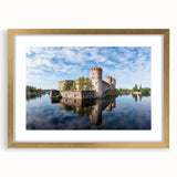 Abstract art print of a European landscape in muted blues and greens, framed in gold, suitable for dining room decor.