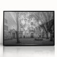 Large abstract wall art depicting a Barcelona cityscape in muted gray and blue tones on a black framed acrylic print.