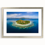Textured art depicting abstract ocean waves in cool blue and white tones on a framed silver mat, ideal for bedroom art.