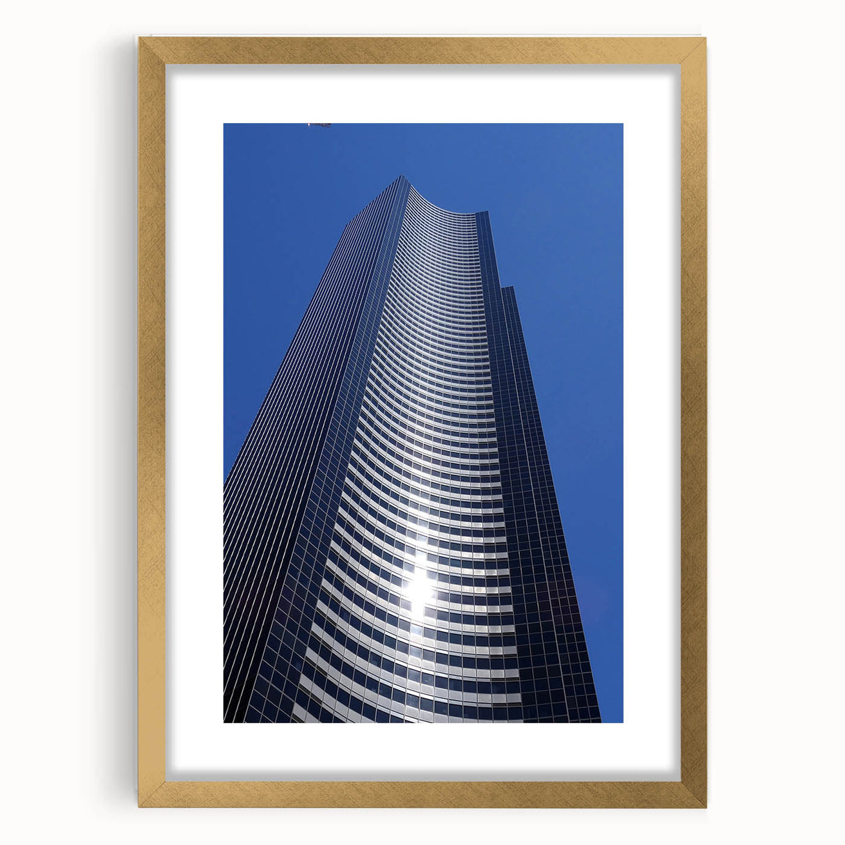 Extra large abstract art print of Seattle skyline in muted gray and blue tones, framed in gold, ideal for living room decor.