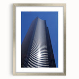 Textured abstract art print of Seattle skyline in muted gray and blue tones on a framed silver mat, ideal for bedroom art.