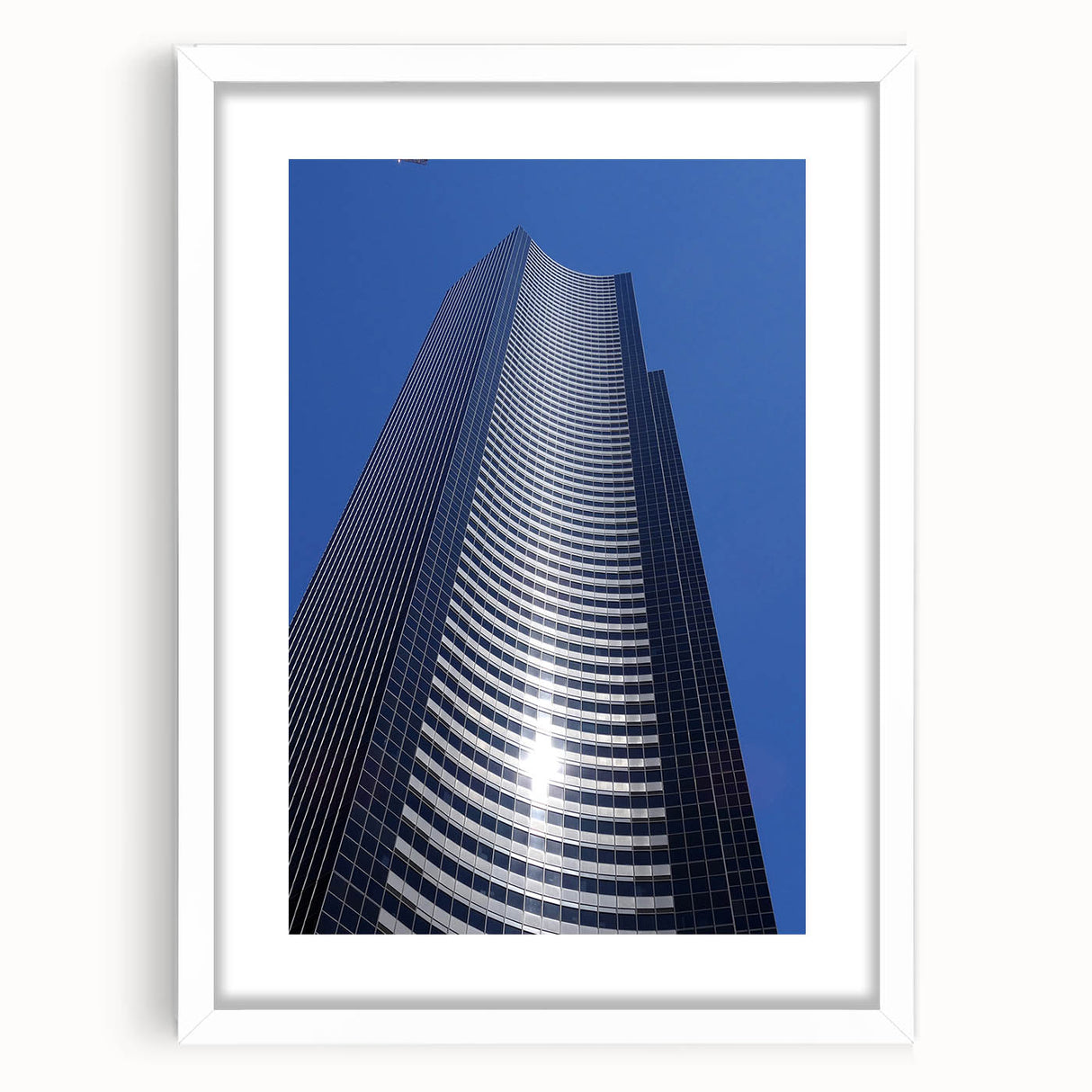 Abstract art print of Seattle skyline in muted gray and blue tones on a framed poster, suitable for dining room decor.