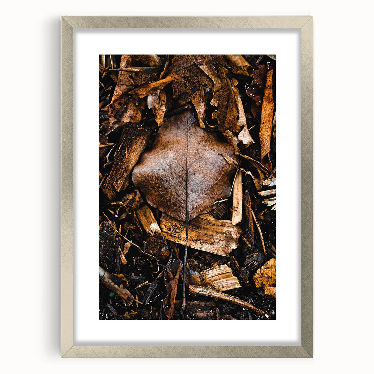Textured abstract art print depicting autumnal colors in a silver frame, suitable for bedroom wall decor.