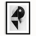 Abstract minimalist wall art frame in black with a white mat, showcasing geometric shapes and soft lines, perfect for modern home decor.