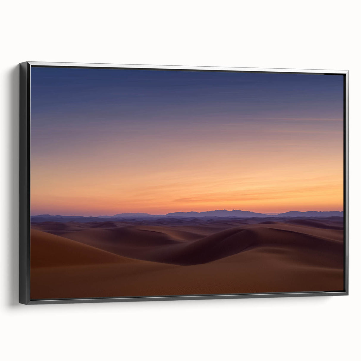 Framed canvas artwork depicting a vibrant desert landscape, featuring warm tones of orange and red with a sleek black frame, ideal for modern home decor.