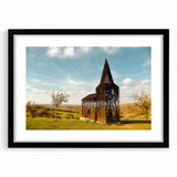 Colorful abstract art print of a European scenery in vibrant hues on a textured, black-framed canvas.