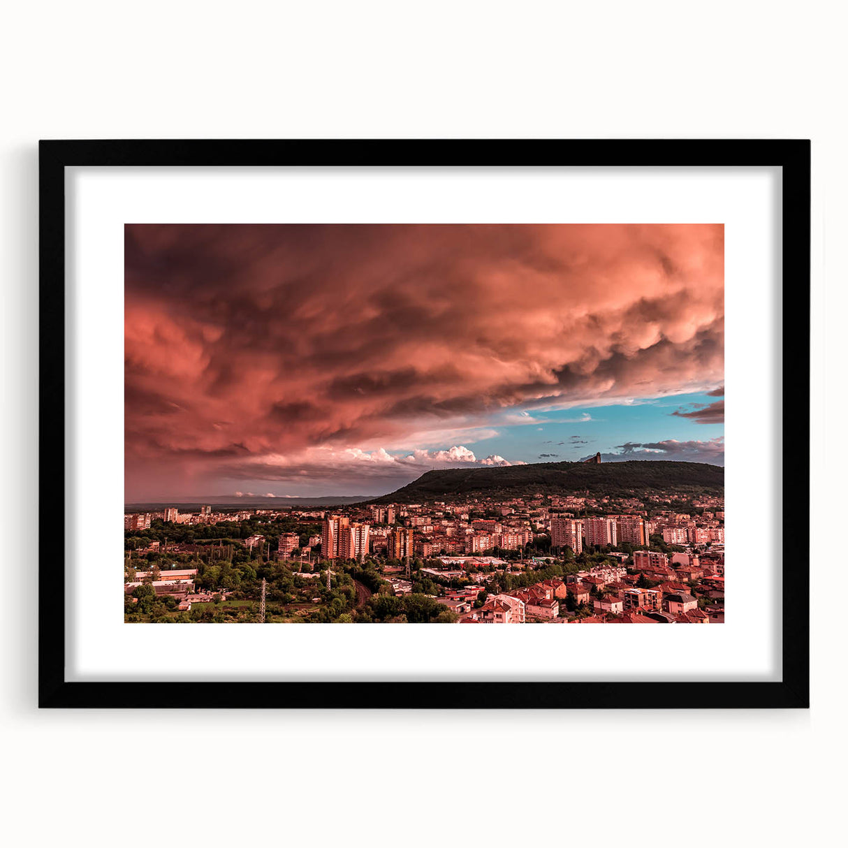 Extra large abstract art print featuring a colorful, textured depiction of a European scenery in a black frame.
