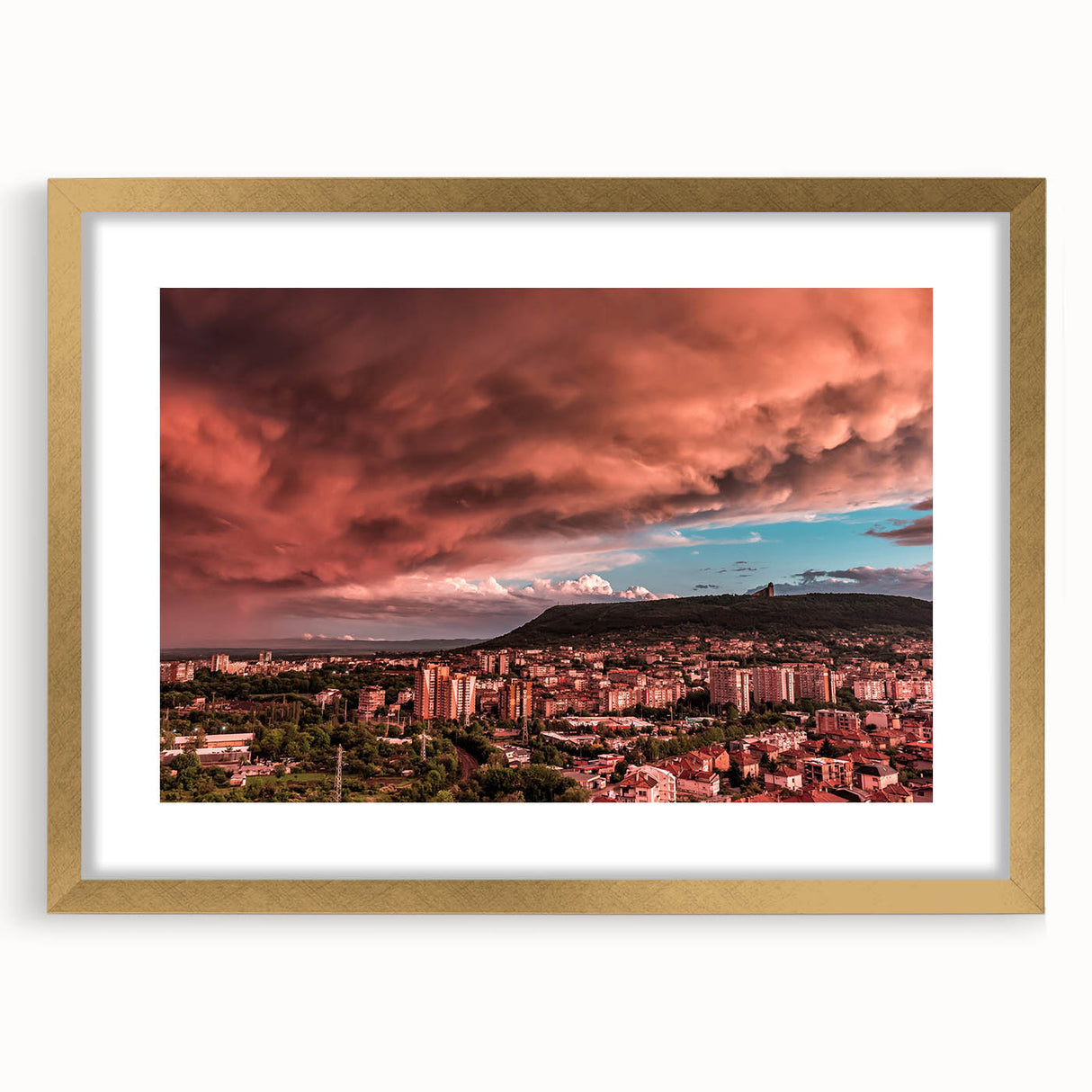 Abstract art print of a European landscape in muted gold and green tones, framed with a gold mat.