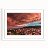 Textured abstract art print of a European scenery in muted earth tones, framed with a white mat, suitable for bedroom decor.