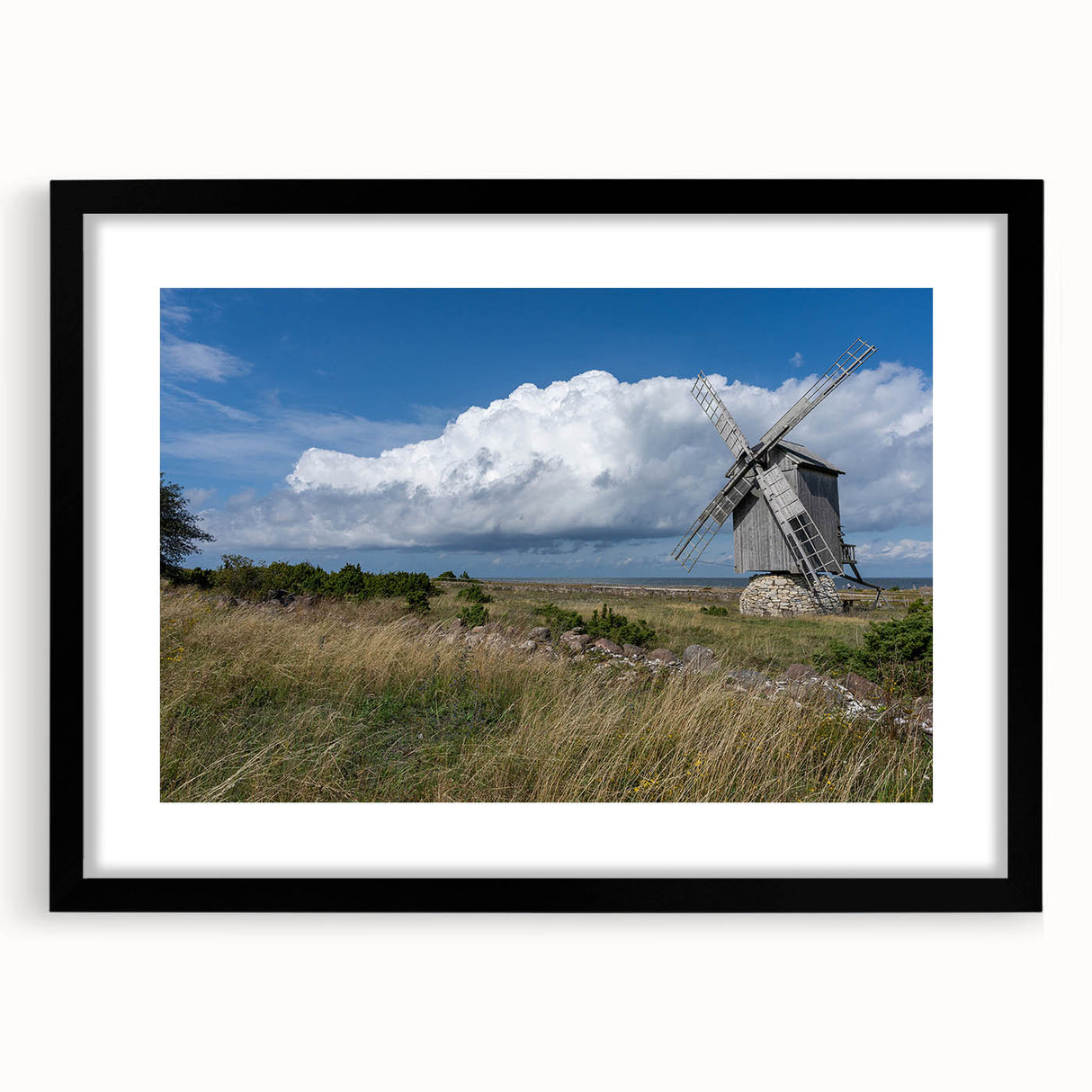 Colorful abstract art print of a European scenery in vibrant hues on a large textured canvas, framed in black.