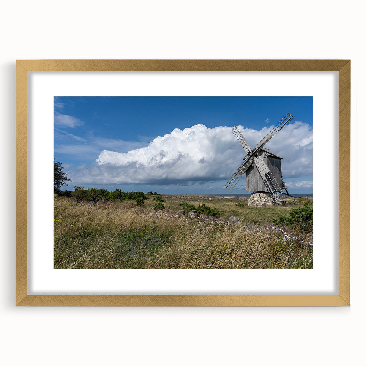 Abstract art print depicting a European landscape in muted earth tones, framed in gold, suitable for dining room decor.