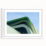 Textured abstract art print depicting a serene European landscape in muted earth tones, framed in white.