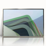 Large art print of a European cityscape in muted gray and blue tones, framed in silver acrylic.