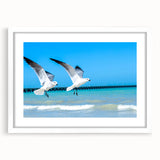 Abstract art print of Yucatan scenery in muted green and blue tones, framed with a white mat, ideal for dining room decor.