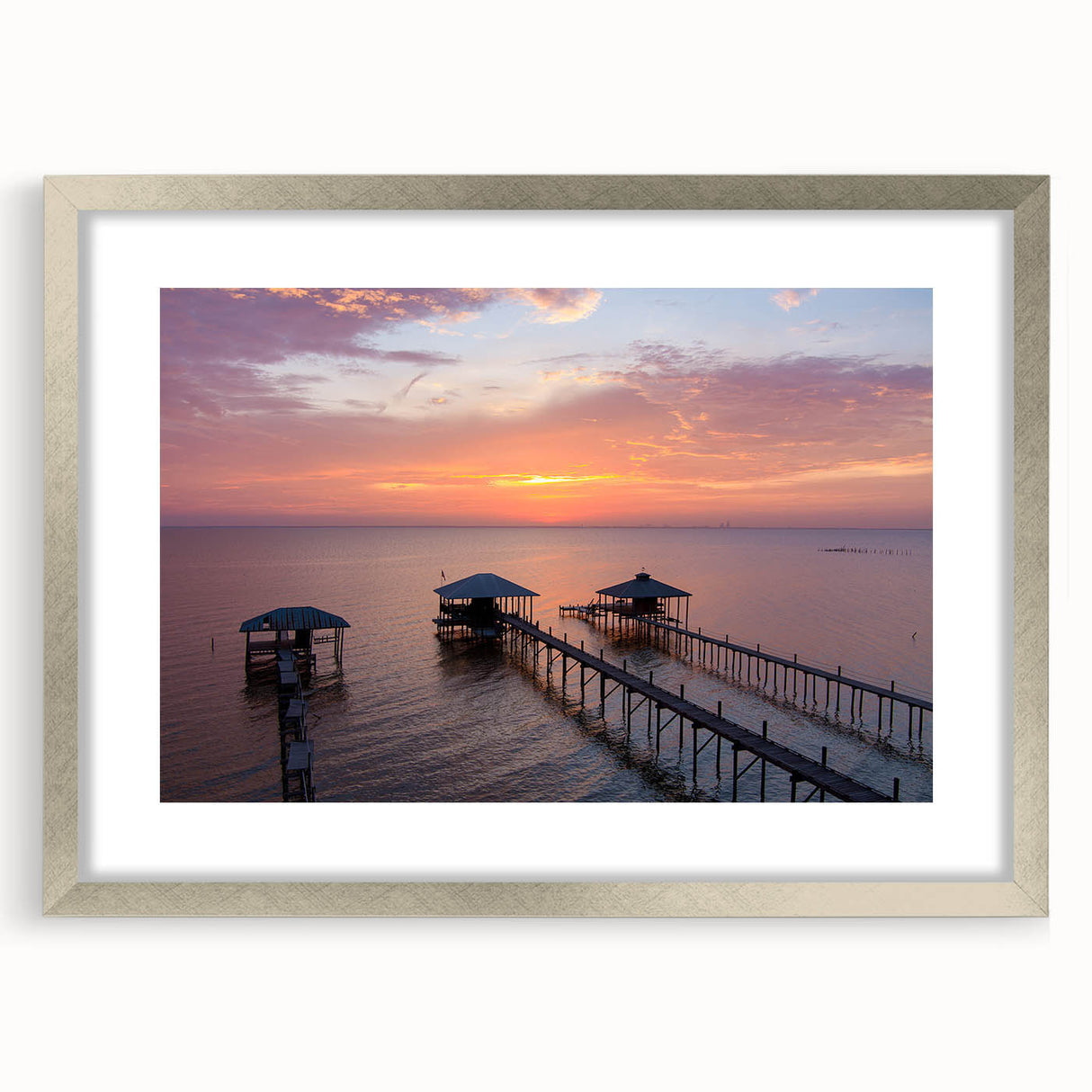 Textured abstract art print of Alabama scenery in muted earth tones on a framed silver mat, ideal for bedroom decor.