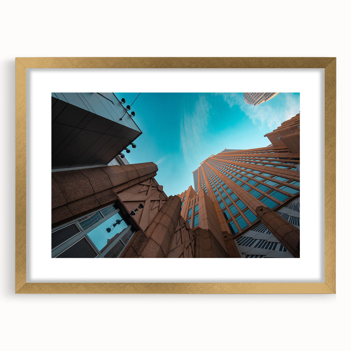 Extra large abstract art print of Charlotte skyline in muted gray and blue tones on a gold-framed canvas.
