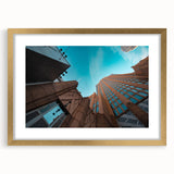 Extra large abstract art print of Charlotte skyline in muted gray and blue tones on a gold-framed canvas.