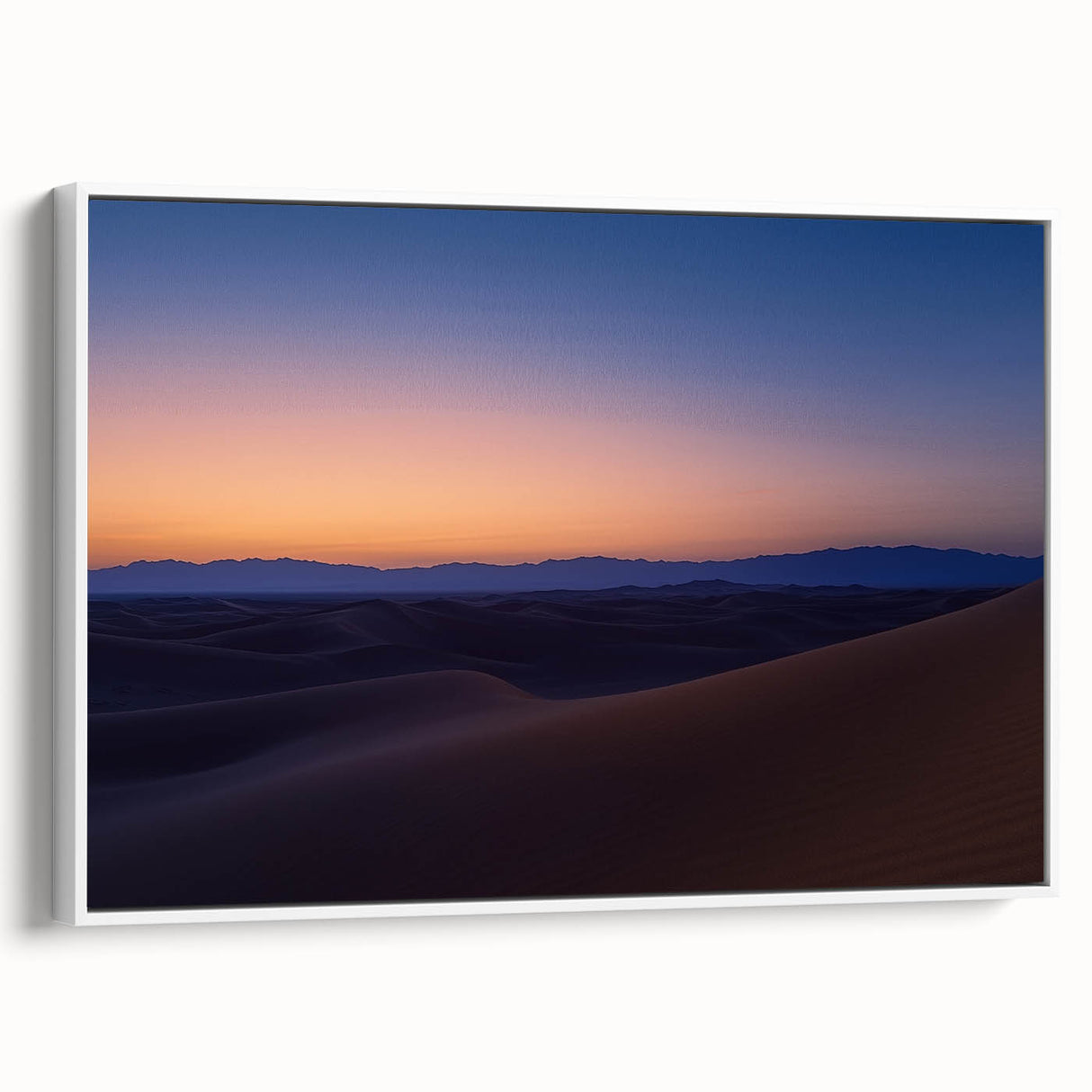 Framed canvas artwork depicting a vibrant desert landscape with warm tones of orange and yellow, set against a white frame, ideal for home decor.