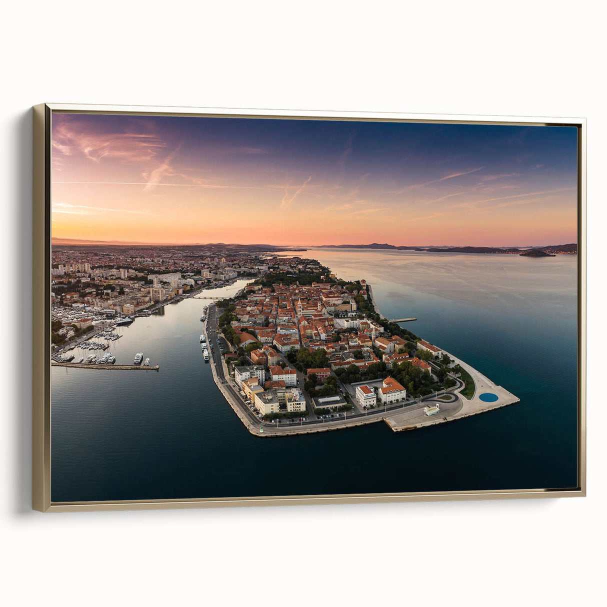 Framed canvas wall art featuring a vintage-style landscape painting of a Croatian coastline in muted earth tones.