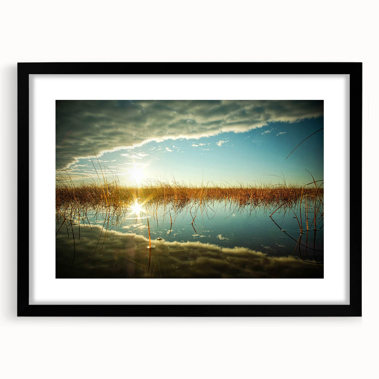 Abstract art print featuring vibrant, colorful textures of a European scenery, framed in black, ideal for living room decor.
