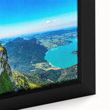 Close-up of a textured, extra large framed canvas depicting a vibrant European scenery in black with colorful accents.