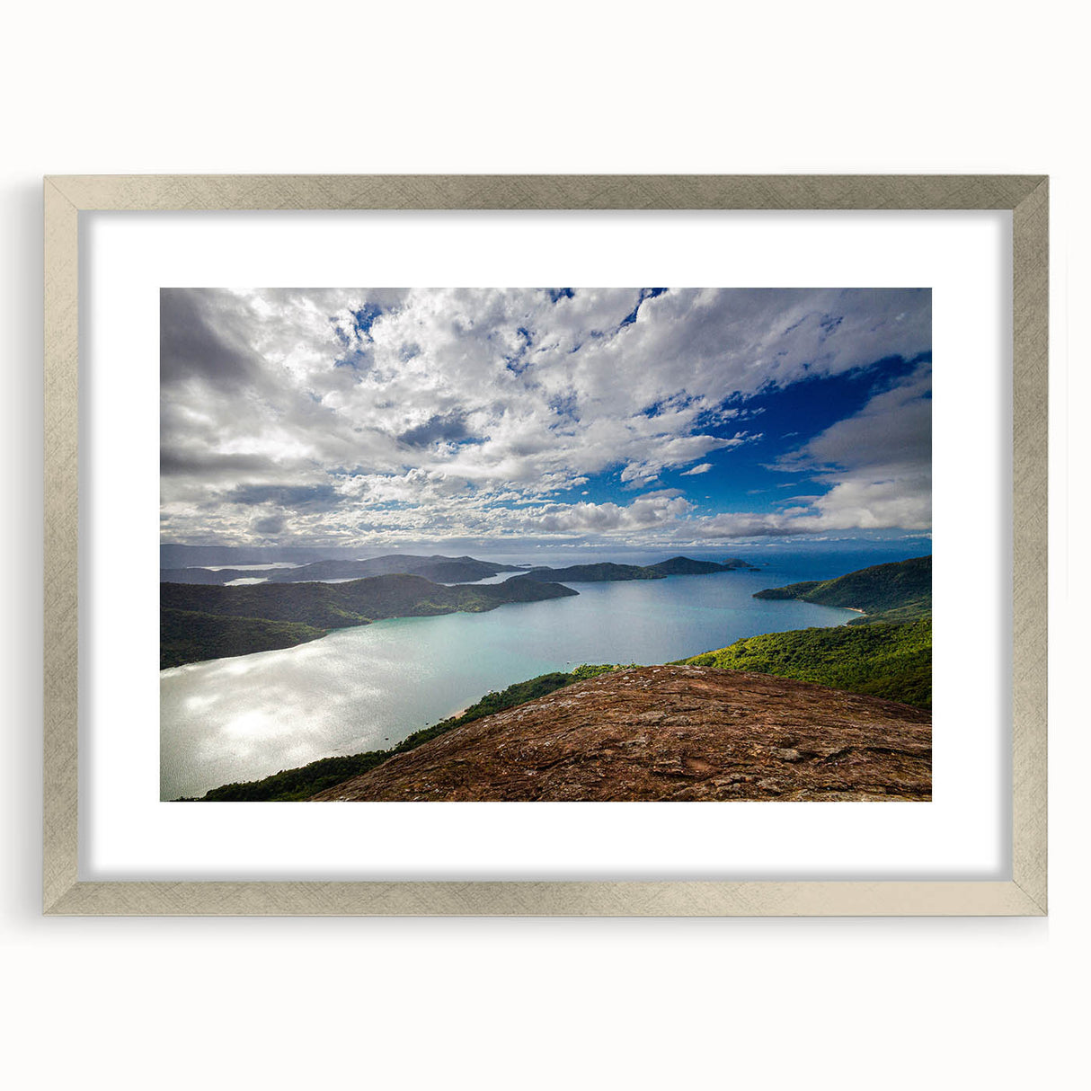 Abstract textured art depicting vibrant hues of a Brazilian landscape on a silver-framed mat.