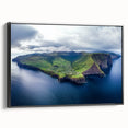 Framed canvas artwork showcasing a breathtaking landscape of rugged cliffs against a vibrant sunset, with a sleek black frame enhancing its modern appeal. Ideal for home decor enthusiasts seeking dramatic nature-inspired art.