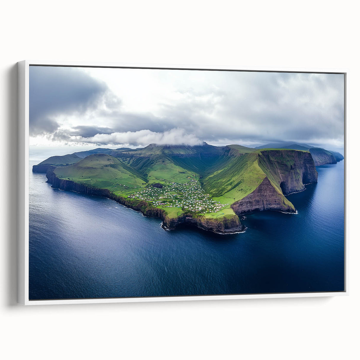 Framed canvas artwork depicting a serene landscape of towering cliffs and lush greenery, showcased in a white frame, perfect for home decor.
