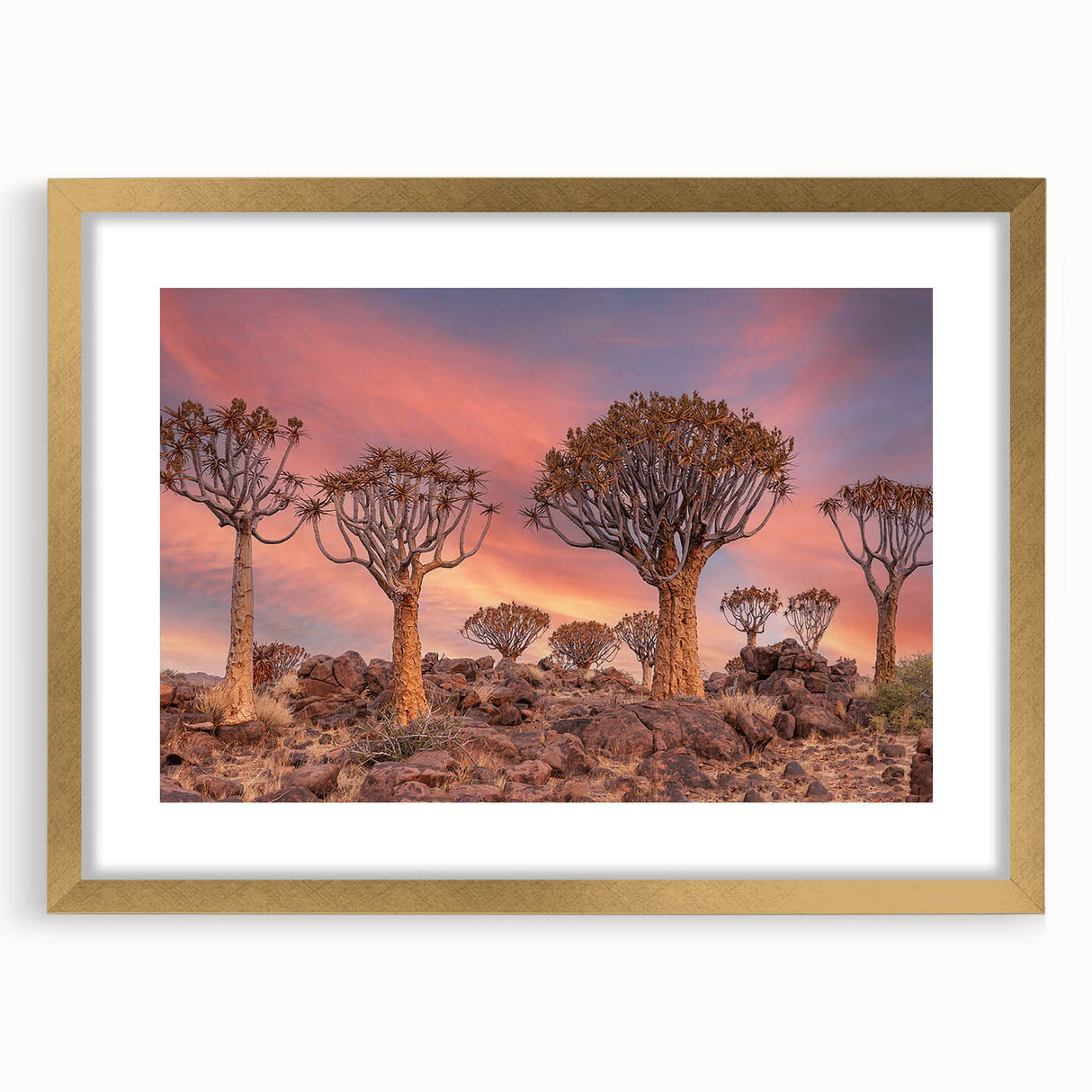 Textured art depicting abstract African scenery in muted earth tones on a gold-framed mat, suitable for bedroom decor.