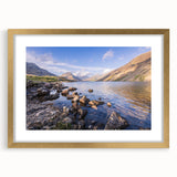 Abstract art print of the Cumbrian landscape in muted green and blue tones, framed in gold, ideal for dining room decor.