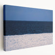 A panoramic view of a European cityscape in muted gray and blue tones on a large stretched canvas.